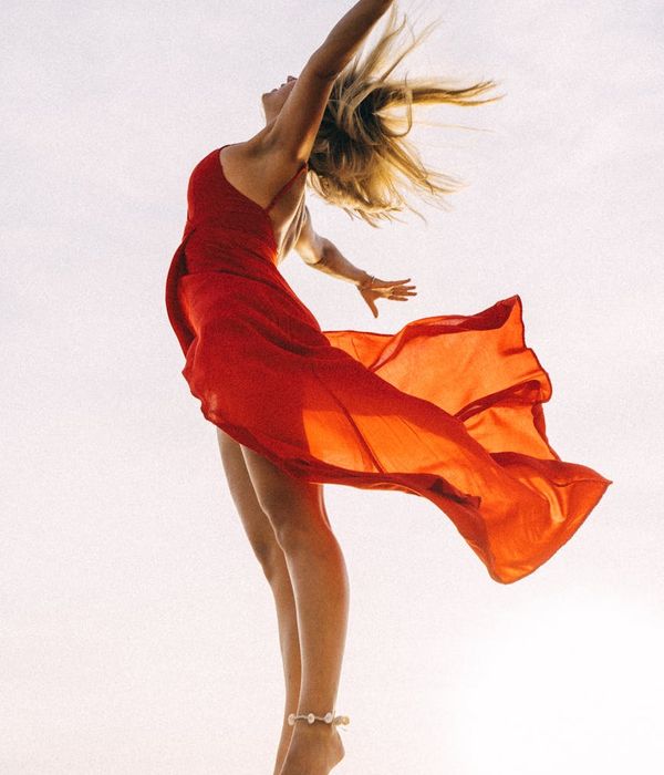 A woman feeling vibrant and energetic in a bright, open space.